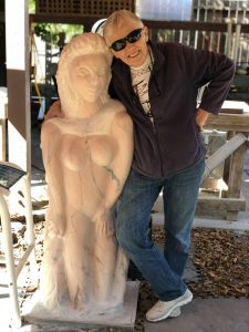 Karen Ryer standing next to sculpture